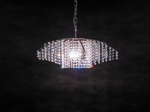 A glorious modern sparkling crystal chandelier sets the mood, a ceiling lamp for every home